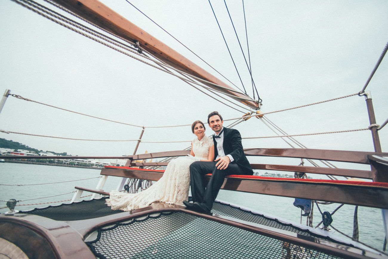 groom and bride sitting in flying sit royal albatross